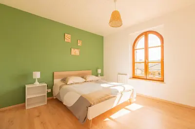Un ou plusieurs lits dans un hébergement de l'établissement Gîte de la Louvière - maison de campagne