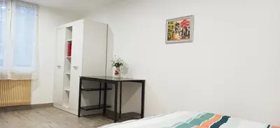 Un ou plusieurs lits dans un hébergement de l'établissement Appartement au rez-de-chaussée avec jardin privé