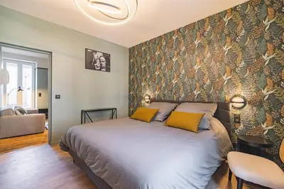 Un ou plusieurs lits dans un hébergement de l'établissement Art Déco Lesage & Spa