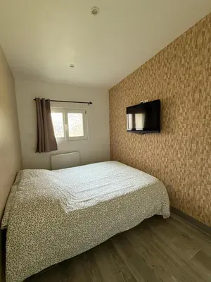 Un ou plusieurs lits dans un hébergement de l'établissement Studio meublé marne la vallée / Disneyland