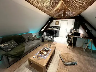 Coin salon dans l'établissement Appartement de Charme