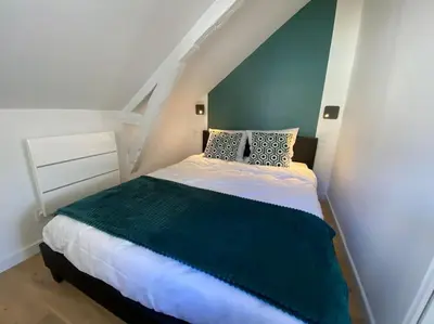 Un ou plusieurs lits dans un hébergement de l'établissement Appartement - Le cocon Rémois