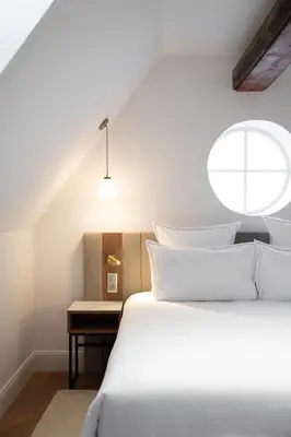 Un ou plusieurs lits dans un hébergement de l'établissement Hôtel Margaux