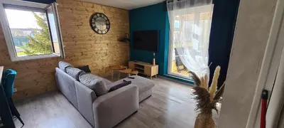 Coin salon dans l'établissement Appartement joli et spacieux