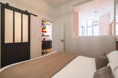 Un ou plusieurs lits dans un hébergement de l'établissement MM Suites Loft Cathédrale