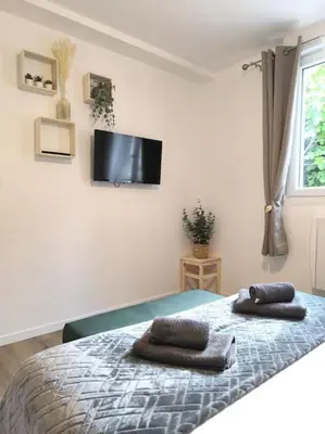 Télévision ou salle de divertissement dans l'établissement NOUVEAU Les Grumes 2 - Maison - 2 chambres - Jardin - Neuf