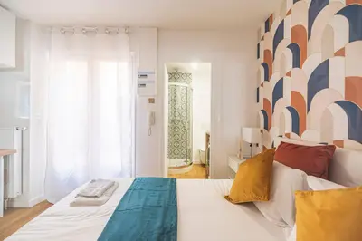 Un ou plusieurs lits dans un hébergement de l'établissement MM Suites Saint-Remi