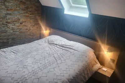 Un ou plusieurs lits dans un hébergement de l'établissement Logement Cosy type Loft près de Saint Quentin