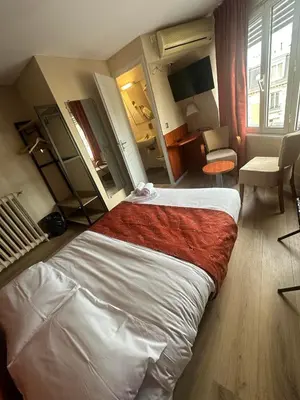 Un ou plusieurs lits dans un hébergement de l'établissement Hôtel Victoria