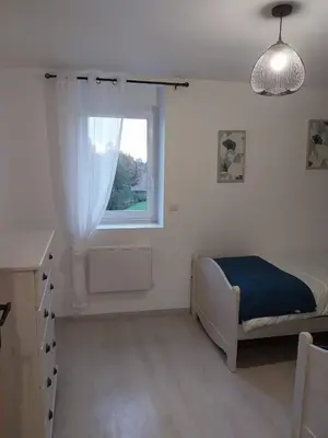 Un ou plusieurs lits dans un hébergement de l'établissement Le murmure du ruisseau - Pièce de vie 60 m2 - Terrasse 30 M2 - 2 WC