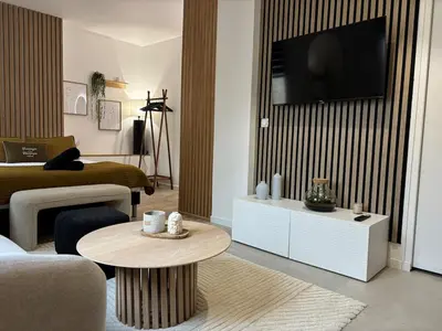 Télévision ou salle de divertissement dans l'établissement Le Lodge