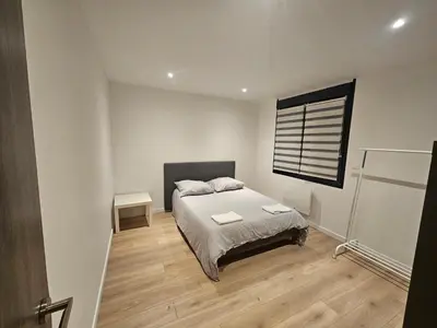 Un ou plusieurs lits dans un hébergement de l'établissement Appartement 75m2 neuf 15 min centre ville
