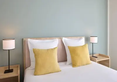 Un ou plusieurs lits dans un hébergement de l'établissement Quality Aparthotel Reims - Saint-Thomas