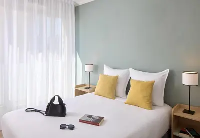 Un ou plusieurs lits dans un hébergement de l'établissement Quality Aparthotel Reims - Saint-Thomas