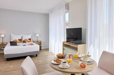 Un ou plusieurs lits dans un hébergement de l'établissement Quality Aparthotel Reims - Saint-Thomas