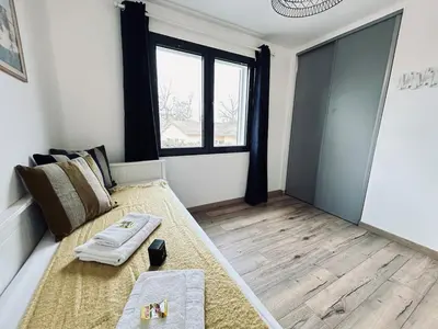Un ou plusieurs lits dans un hébergement de l'établissement La maison des vignes 3chambres jardin proche Reims