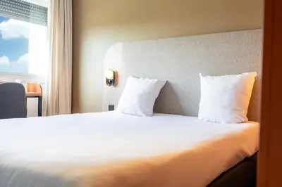 Un ou plusieurs lits dans un hébergement de l'établissement Hôtel AKENA Chalons-en-Champagne