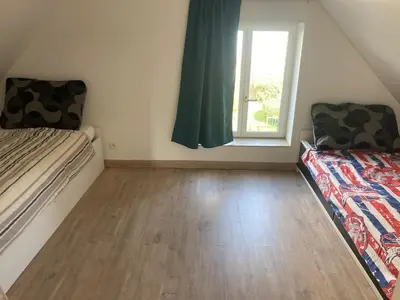 Un ou plusieurs lits dans un hébergement de l'établissement Jolie petite maison de campagne