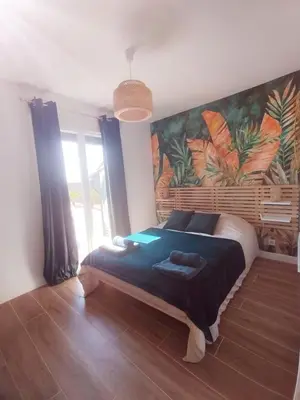 Un ou plusieurs lits dans un hébergement de l'établissement Le Chalet Tropical