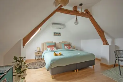 Un ou plusieurs lits dans un hébergement de l'établissement Gîte Marotte - Climatisé avec Jardin