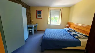 Un ou plusieurs lits dans un hébergement de l'établissement Gîte LA COUMERETTE