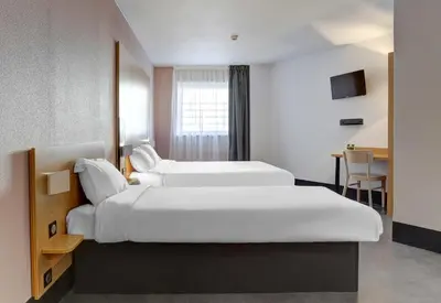 Un ou plusieurs lits dans un hébergement de l'établissement B&B HOTEL Reims Centre Gare
