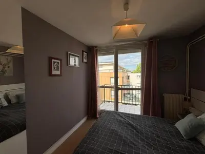 Un ou plusieurs lits dans un hébergement de l'établissement City break Reims - Grand balcon