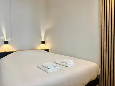 Un ou plusieurs lits dans un hébergement de l'établissement Wellness Suite Ponsardin RDC - Reims Centre