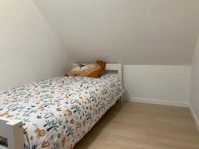 Un ou plusieurs lits dans un hébergement de l'établissement Appartement duplex au calme