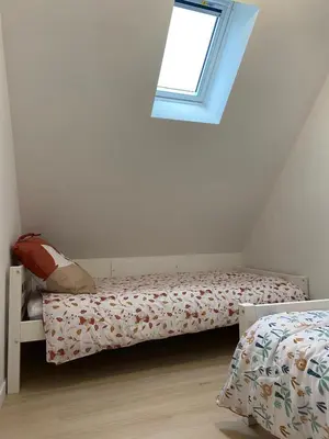 Un ou plusieurs lits dans un hébergement de l'établissement Appartement duplex au calme