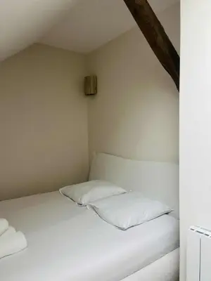 Un ou plusieurs lits dans un hébergement de l'établissement Suite Muraille by Collection Aura - 4p - Hypercentre Charleville-Mézières à deux pas de la Place Ducale