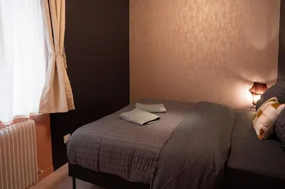 Un ou plusieurs lits dans un hébergement de l'établissement Le Jardin Secret - Zen en Centre St-Quentin