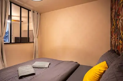 Un ou plusieurs lits dans un hébergement de l'établissement Terres de Soleil - Bohème Chic en cœur St Quentin