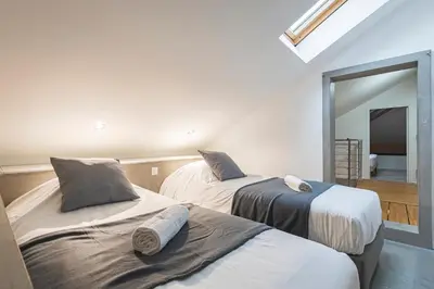 Un ou plusieurs lits dans un hébergement de l'établissement MM Suites City House Cathedrale