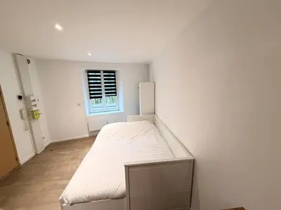 Un ou plusieurs lits dans un hébergement de l'établissement C Coispine charmant studio en RDC face à la meuse