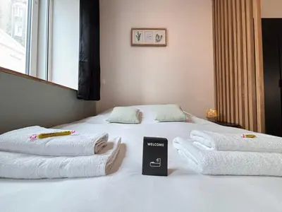 Un ou plusieurs lits dans un hébergement de l'établissement Le Rainssant studio cocooning en RDC au centre