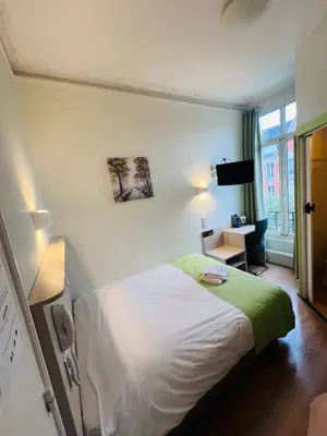 Un ou plusieurs lits dans un hébergement de l'établissement Hôtel De La Cathédrale