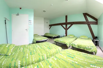 Un ou plusieurs lits dans un hébergement de l'établissement Maison accueillante près de Monthenault, parfaite pour groupes