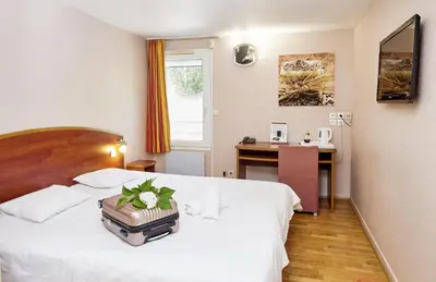 Un ou plusieurs lits dans un hébergement de l'établissement Logis Hotel Restaurant Bagatelle - 51530 Dizy