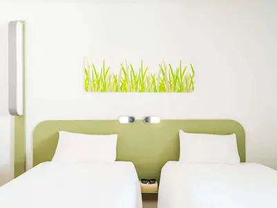 Un ou plusieurs lits dans un hébergement de l'établissement ibis budget Noyon