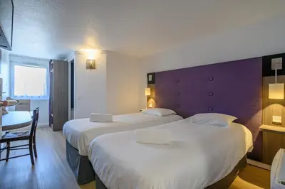 Un ou plusieurs lits dans un hébergement de l'établissement Brit Hotel Reims La Neuvillette