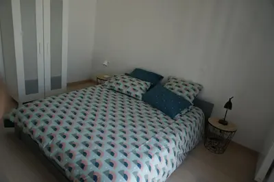 Un ou plusieurs lits dans un hébergement de l'établissement Appartement Forum Reims