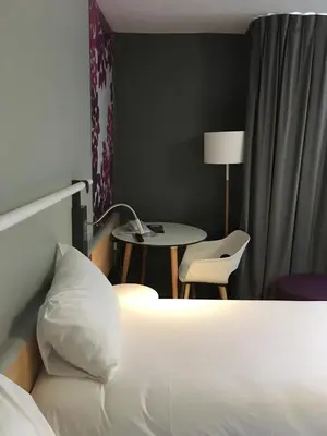 Un ou plusieurs lits dans un hébergement de l'établissement Ibis Laon - Hôtel Restaurant
