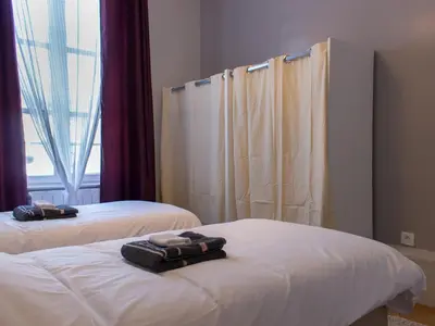 Un ou plusieurs lits dans un hébergement de l'établissement Trankil Apparts centre
