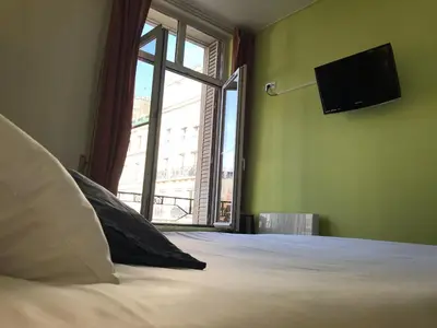 Un ou plusieurs lits dans un hébergement de l'établissement Hotel Aux Sacres Reims, Centre Historique