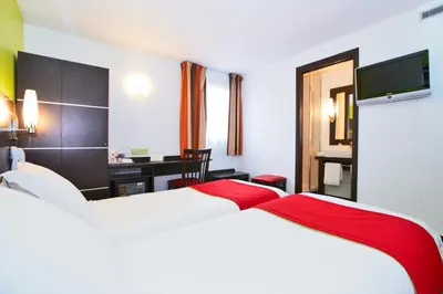 Un ou plusieurs lits dans un hébergement de l'établissement Enzo Hotels Reims Tinqueux