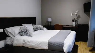 Un ou plusieurs lits dans un hébergement de l'établissement Hôtel des Arcades