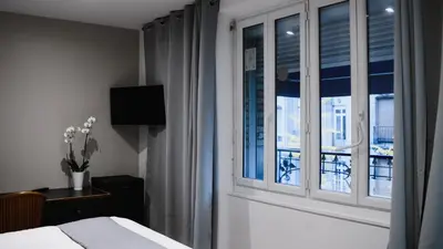Un ou plusieurs lits dans un hébergement de l'établissement Hôtel des Arcades