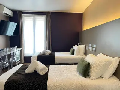 Un ou plusieurs lits dans un hébergement de l'établissement HOTEL & SPA Le Renard Centre