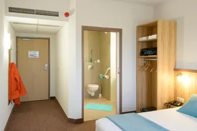 Un ou plusieurs lits dans un hébergement de l'établissement Brit Hotel Reims Croix Blandin